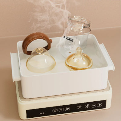 Biberon en verre incassable et tétines stérilisés à la vapeur haute température, hygiène et sécurité bébé.