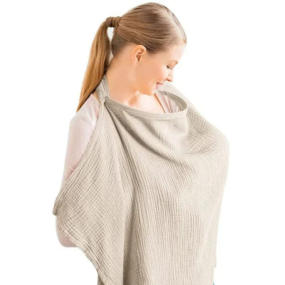 Cape d’allaitement beige aux tons naturels, pratique pour l’allaitement, les balades, et les moments de complicité avec bébé.