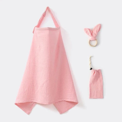 Cape d’allaitement rose poudré en gaze de coton, fournie avec anneau de dentition et pochette, pour allaiter bébé avec douceur et élégance.
