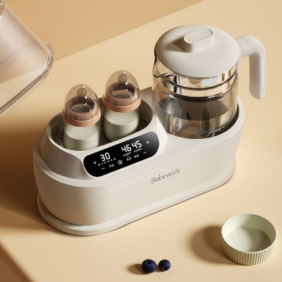 Chauffe biberon multifonction avec deux biberons en cours de chauffe et pot en verre pour chauffer purée ou soupe bébé.