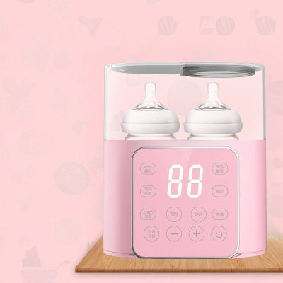 Chauffe biberon rose au design compact avec deux biberons en chauffe et commandes tactiles pour réchauffer et stériliser rapidement.