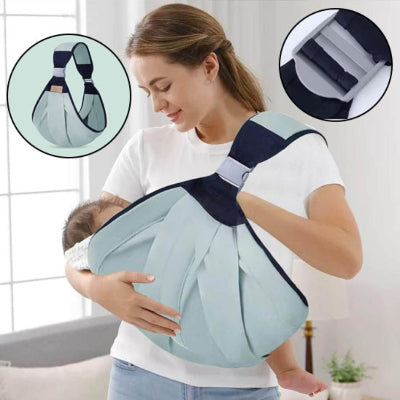 Maman souriante portant bébé contre elle dans une écharpe de portage vert menthe, lien émotionnel renforcé et liberté de mouvement.