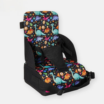 Coussin rehausseur chaise pliable pour bébé motif dinosaures, siège repas bébé pratique, idéal pour les repas à la maison ou en voyage.
