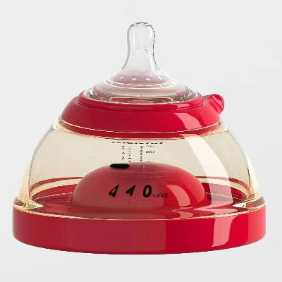 Biberon en forme de sein transparent avec graduation et base rouge, design ergonomique.