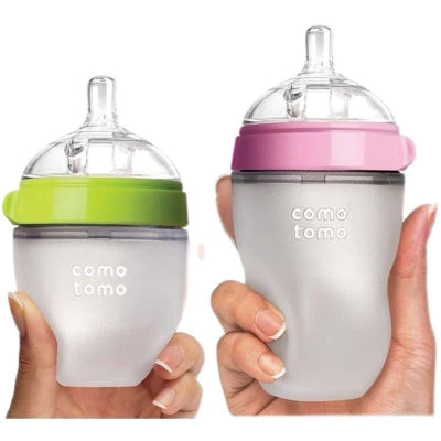 Biberon Como Tomo en silicone médical, format 150 ml vert citron et 250 ml rose, avec tétine souple imitation sein pour une transition allaitement tout en douceur.