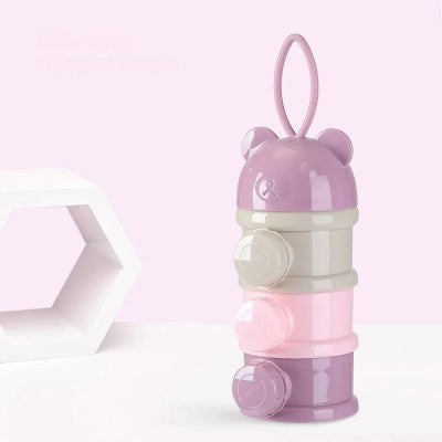  Boite doseuse lait LactoPop™ violet avec ouverture latérale à bouchons vissables pour verser facilement la poudre dans un biberon.