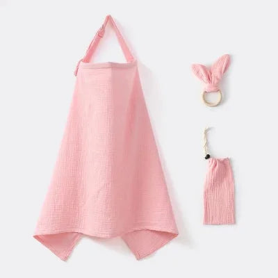 Cape d’allaitement rose poudré en gaze de coton, fournie avec anneau de dentition et pochette, pour allaiter bébé avec douceur et élégance.