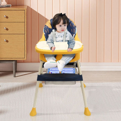 Bébé attaché avec harnais dans une chaise haute évolutive jaune et bleu, plateau amovible devant lui, chaise haute évolutive sécurisée pour repas et jeux.