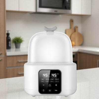 Chauffe biberon multifonction blanc dans une cuisine moderne, parfait pour réchauffer lait et purée en toute discrétion.