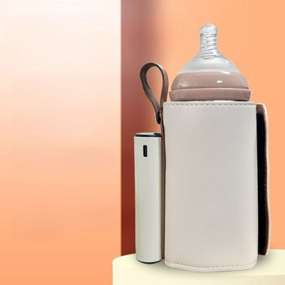 Chauffe biberon sans fil coloris beige avec batterie USB-C intégrée et support pour biberon standard, parfait pour les déplacements.