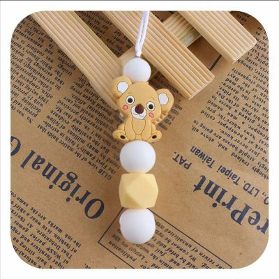 Collier d’allaitement jaune soleil avec pendentif koala, fabriqué en silicone alimentaire, allie sécurité, fun et stimulation tactile pour bébé.