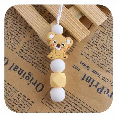 Collier d’allaitement jaune soleil avec pendentif koala, fabriqué en silicone alimentaire, allie sécurité, fun et stimulation tactile pour bébé.