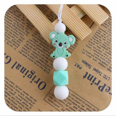 Collier d’allaitement vert menthe avec koala rigolo, attire l’attention de bébé, prévient les tirages de cheveux et aide à soulager les dents.