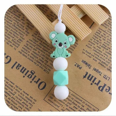 Collier d’allaitement vert menthe avec koala rigolo, attire l’attention de bébé, prévient les tirages de cheveux et aide à soulager les dents.