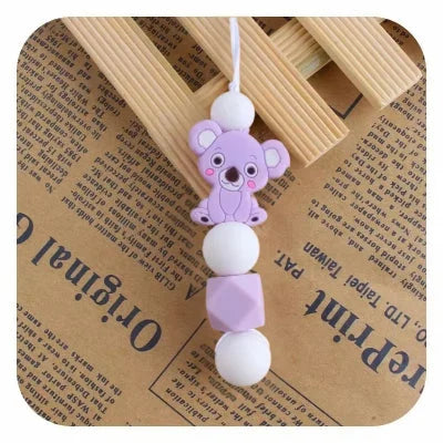 Collier d’allaitement violet en silicone alimentaire, orné d’un adorable koala, conçu pour éveiller bébé et soulager ses gencives sensibles.