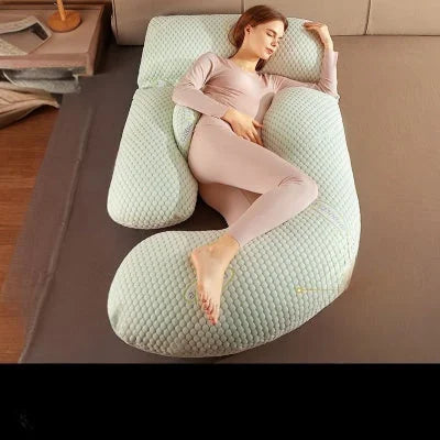 Coussin de grossesse Proactif vert avec maille douce, utilisé en position latérale pour soulager le dos et améliorer la circulation pendant la grossesse.