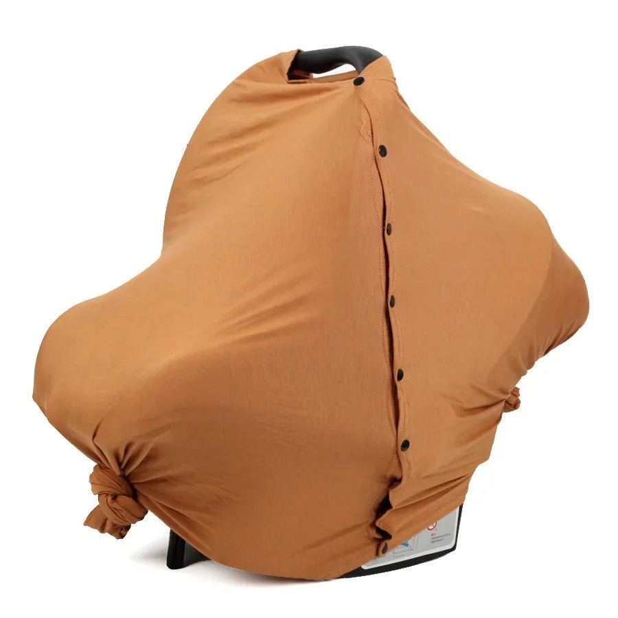 DouceEnvol™ caramel utilisée comme housse de siège auto bébé — protection coton jersey terracotta