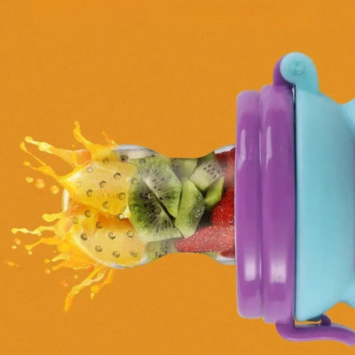 grignoteuse pour bébé montrant l’embout en silicone micro-perforé avec des morceaux de fruits