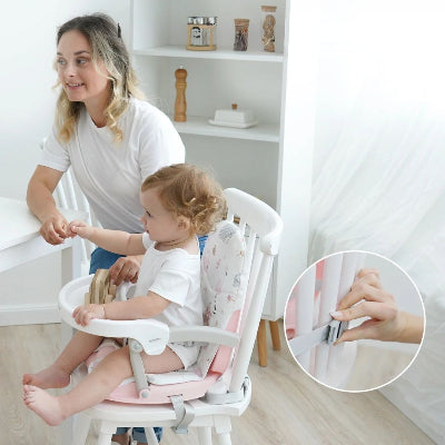 Rehausseur chaise bébé pliable fixé solidement à une chaise avec doubles sangles de sécurité, assurant stabilité et confort à l’enfant pendant les repas.