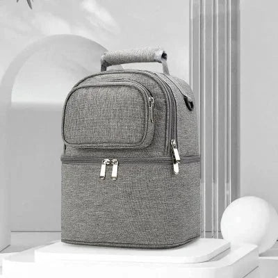 Sac isotherme Bebe gris BibiCool™ à double zip, conçu pour conserver le lait maternel et les biberons à température idéale.