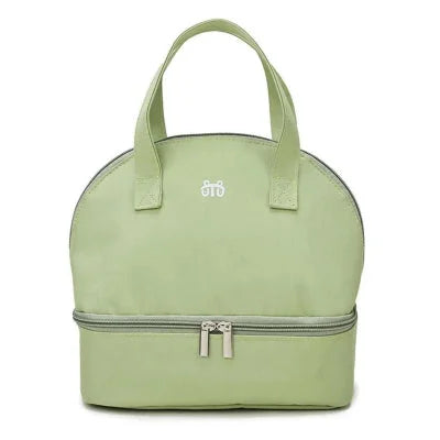 Sac isotherme de transport pour bébé en vert pastel, léger et multifonction, adapté à la crèche ou au pique-nique.