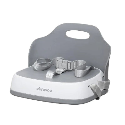Siège repas bébé gris compact et pliable, réhausseur chaise enfant pratique avec harnais 3 points et dossier ergonomique.